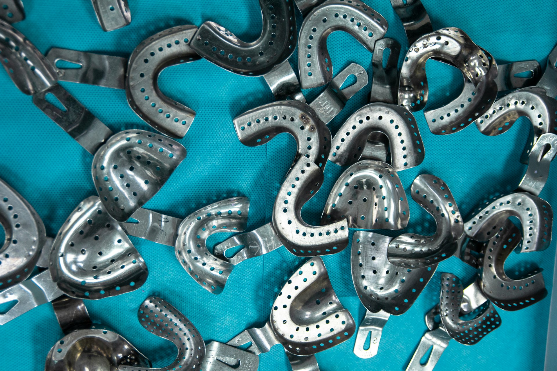 a bunch of metal objects that are on a blue surface